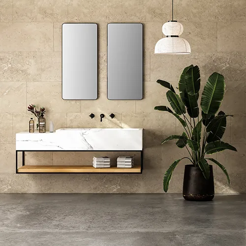 Badezimmer Helles, minimalistisches Badezimmer-Interieur mit weißem Marmorwaschbecken und Doppelspiegeln, Badewanne, Pflanze, Betonboden und beigefarbenen Wandfliesen.